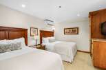 This inviting bedroom features two twin beds with plush bedding and decorative pillows, promising a restful night's sleep.