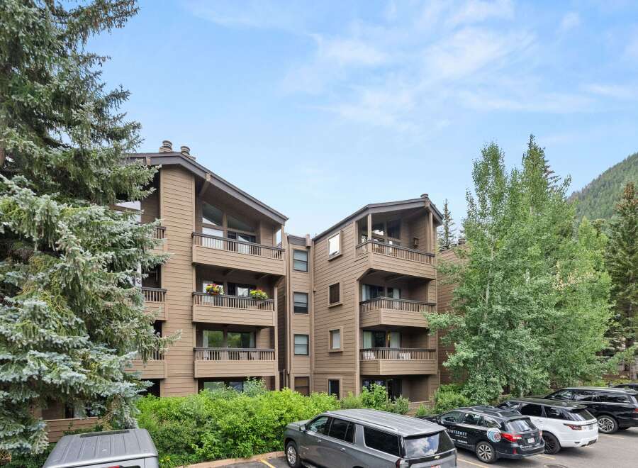 Discover the charm of this multi-story condo nestled amidst lush greenery.