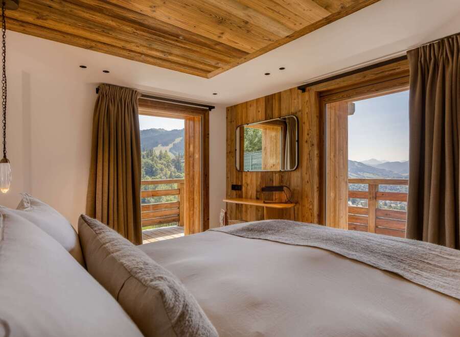 Experience luxury living in this chalet-style bedroom with stunning mountain views.