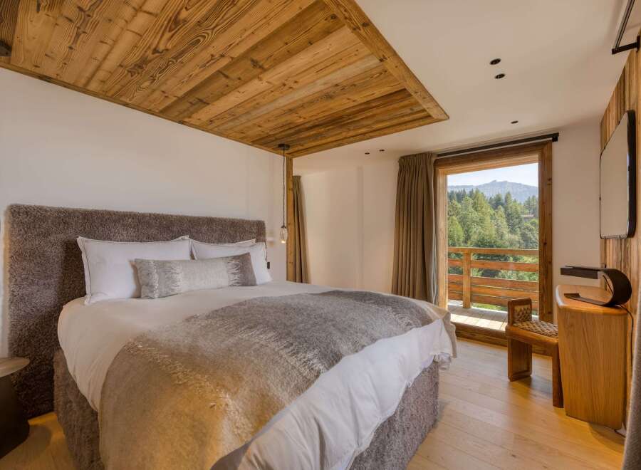 Experience luxury in this stunning bedroom with a king-size bed and a cozy, oversized headboard.