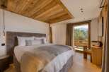 Experience luxury in this stunning bedroom with a king-size bed and a cozy, oversized headboard.
