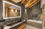 This stunning bathroom showcases rustic charm with its wooden ceiling beams and accent wall, creating a warm and inviting atmosphere.