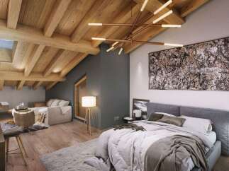 This cozy attic bedroom offers a blend of rustic charm and modern elegance.