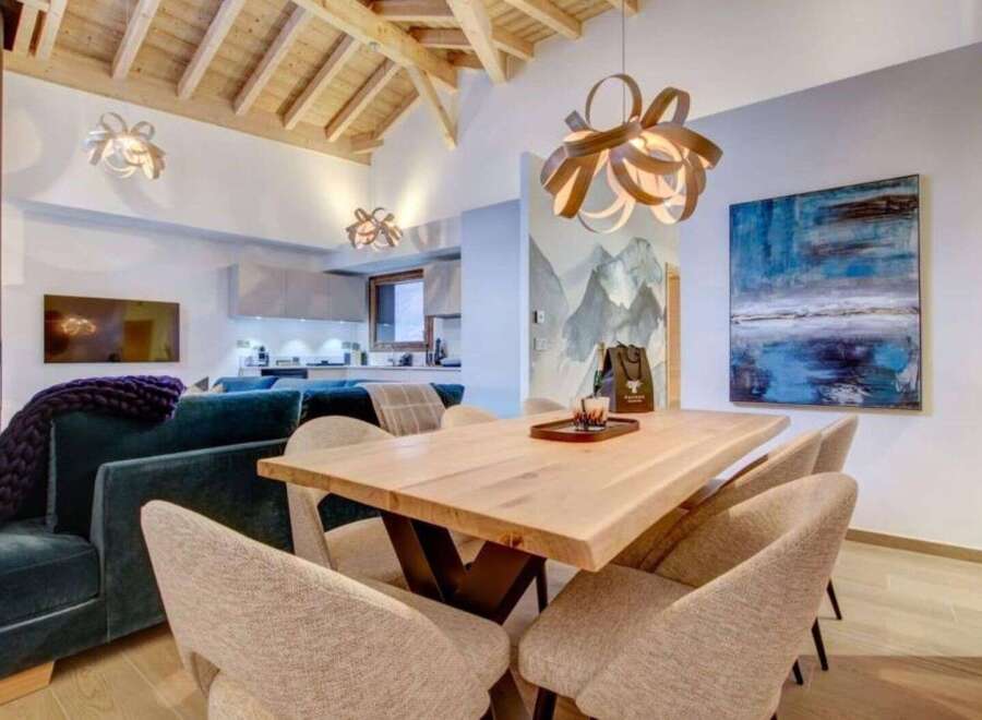 Step inside this stunning property featuring an open-concept living space with vaulted wood ceilings.