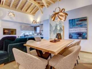 Step inside this stunning property featuring an open-concept living space with vaulted wood ceilings.