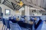 Step into luxury with this stunning property showcasing a dining area perfect for entertaining.