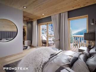 This luxurious bedroom boasts a private balcony with stunning mountain views, perfect for a serene retreat.