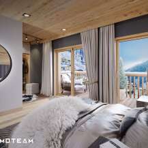 This luxurious bedroom boasts a private balcony with stunning mountain views, perfect for a serene retreat.