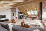 This is a stunning chalet-style apartment with exposed wooden beams and an open-concept living area.