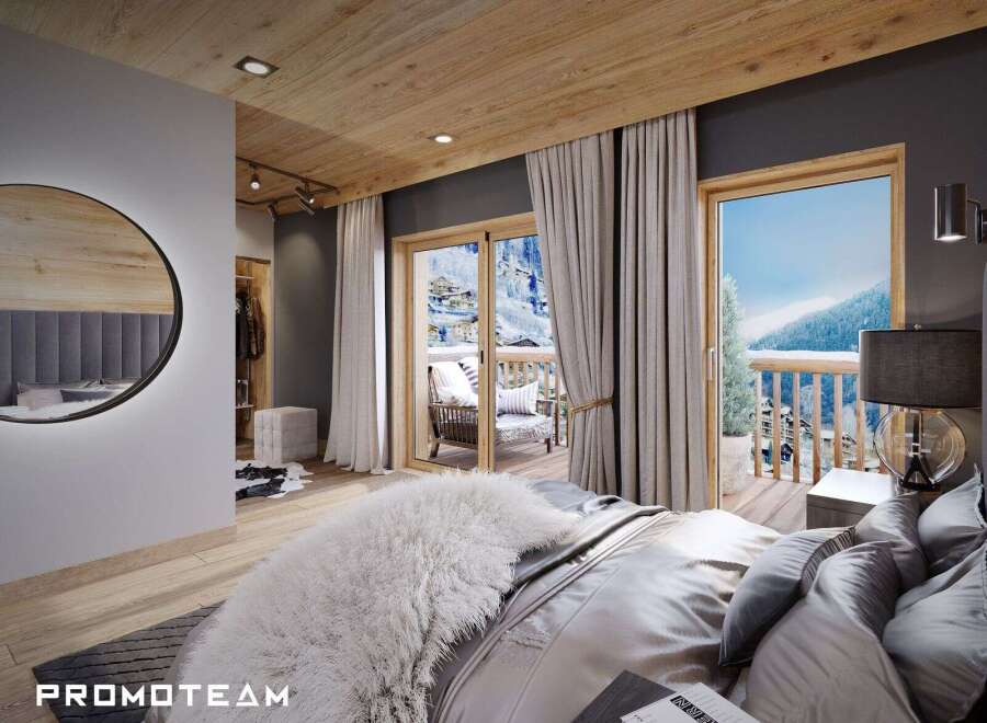 This luxurious bedroom boasts a private balcony with stunning mountain views, perfect for a serene retreat.