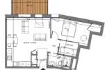 This floor plan showcases a well-designed apartment featuring a living-kitchen area that extends to a balcony, providing a seamless indoor-outdoor living experience.