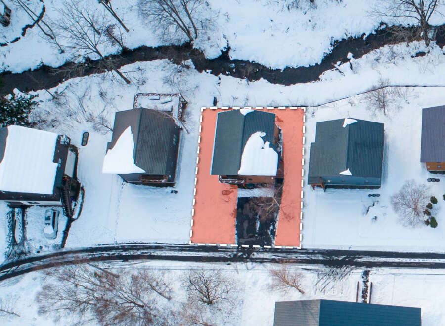 This property offers a serene winter retreat with a home nestled amidst snow-covered landscapes.