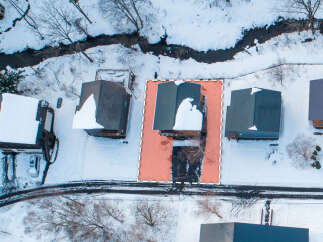 This property offers a serene winter retreat with a home nestled amidst snow-covered landscapes.