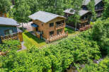 Discover this charming chalet nestled amongst lush greenery.