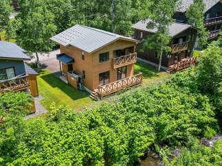 Discover this charming chalet nestled amongst lush greenery.