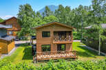 This beautiful two-story house boasts a charming wooden exterior and inviting balconies.