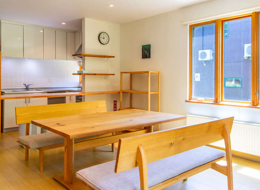 This inviting dining area features a wooden table with bench seating, perfect for family meals or entertaining guests.