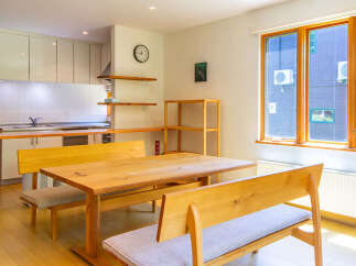 This inviting dining area features a wooden table with bench seating, perfect for family meals or entertaining guests.