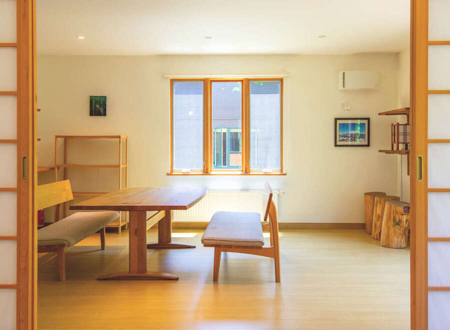This bright and airy home features traditional Japanese shoji screens, creating a serene and minimalist aesthetic.