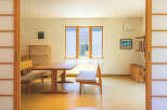 This bright and airy home features traditional Japanese shoji screens, creating a serene and minimalist aesthetic.