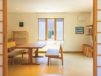 This bright and airy home features traditional Japanese shoji screens, creating a serene and minimalist aesthetic.