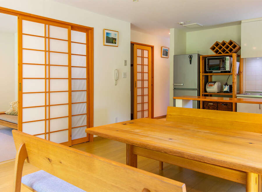 This well-lit, open-concept living space features traditional Japanese shoji sliding doors that offer privacy and style.
