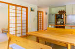 This well-lit, open-concept living space features traditional Japanese shoji sliding doors that offer privacy and style.