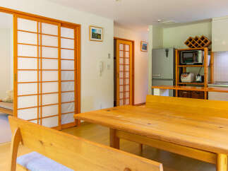 This well-lit, open-concept living space features traditional Japanese shoji sliding doors that offer privacy and style.