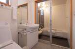 This bathroom features a modern design with a combined toilet and sink area for space efficiency.