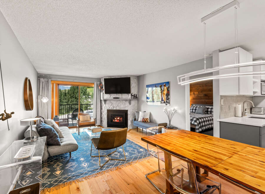 This inviting living space boasts a stone fireplace and a flat-screen TV, perfect for cozy evenings.