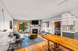 This inviting living space boasts a stone fireplace and a flat-screen TV, perfect for cozy evenings.