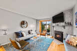 This inviting living room features a cozy fireplace with a mounted TV above, perfect for relaxing evenings.