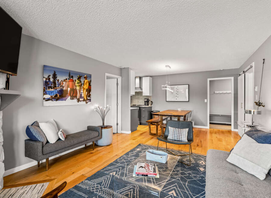 This inviting living space features hardwood floors, a cozy fireplace, and modern decor.