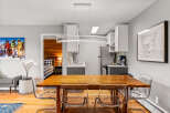 This inviting condo features a dining area with a wooden table and modern, transparent chairs, perfect for entertaining.