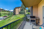 Enjoy outdoor living on this condo's private balcony featuring a grill.