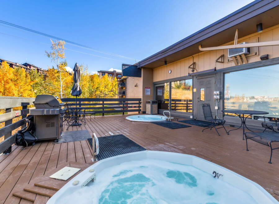Indulge in relaxation at this property featuring a spacious outdoor deck with inviting hot tubs, perfect for unwinding after a day of activities.