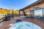 Indulge in relaxation at this property featuring a spacious outdoor deck with inviting hot tubs, perfect for unwinding after a day of activities.