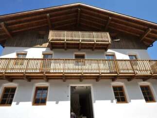 This stunning property boasts a classic design with a charming wooden balcony, offering a perfect blend of traditional and modern elements.