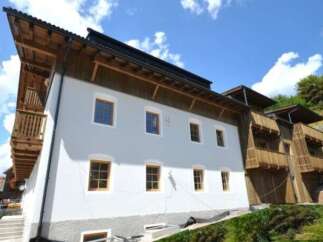 This stunning property boasts a unique architectural design, featuring a combination of wood and modern elements.