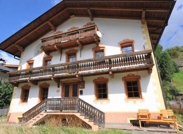 This stunning property boasts traditional architecture with charming wooden balconies and intricate detailing.