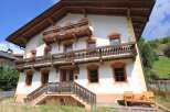 This stunning property boasts traditional architecture with charming wooden balconies and intricate detailing.