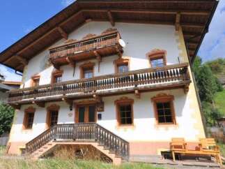 This stunning property boasts traditional architecture with charming wooden balconies and intricate detailing.