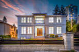 This stunning two-story home features a modern design with large windows and a charming balcony.