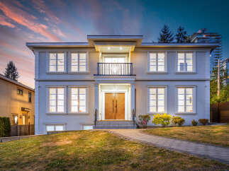This is a two-story house boasts a stunning exterior with a balcony, complemented by a meticulously maintained lawn.