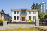 This is a stunning two-story house with a modern design, featuring large windows that offer plenty of natural light.
