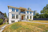 This stunning two-story house boasts a modern design with large windows, offering plenty of natural light.