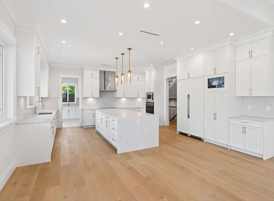 This is a bright and spacious kitchen with an open concept design, perfect for modern living.
