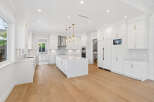 This is a bright and spacious kitchen with an open concept design, perfect for modern living.