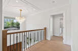 This home features a luxurious foyer with a stunning chandelier and grand staircase.