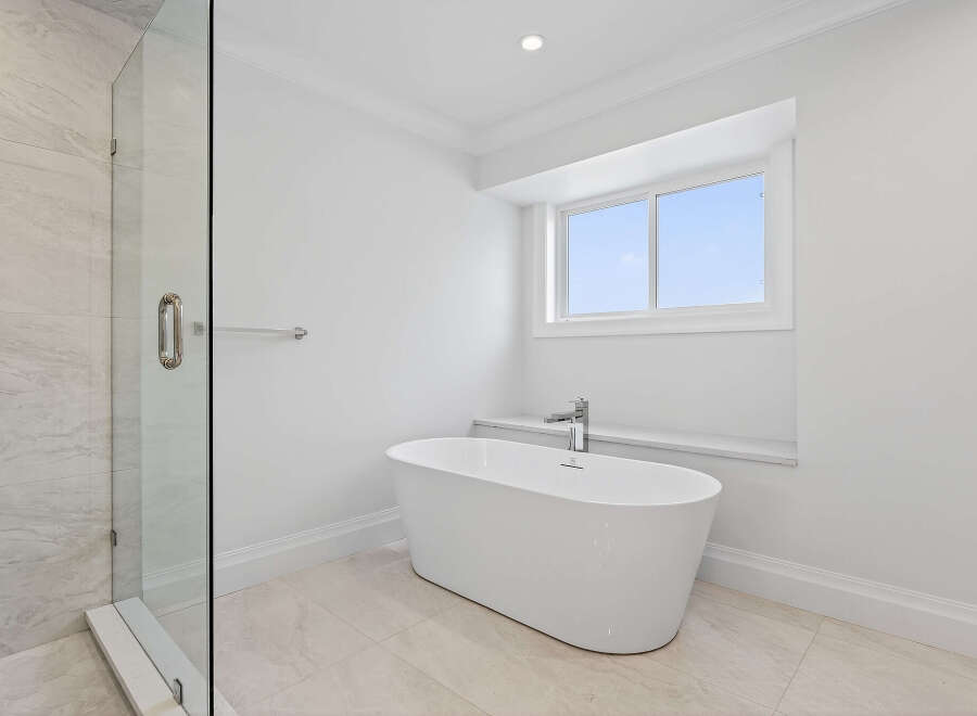 This bathroom features a modern freestanding bathtub paired with a sleek faucet, creating a spa-like ambiance.